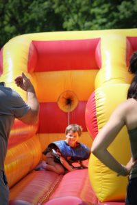 Kid playing on a bounce house.